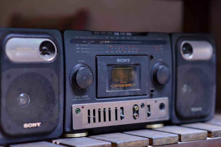 Close-up of a vintage Sony boombox cassette player with speakers on a wooden surface.